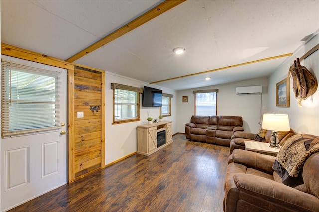 living room featuring baseboards, dark wood finished floors, a wall mounted air conditioner, lofted ceiling with beams, and a fireplace