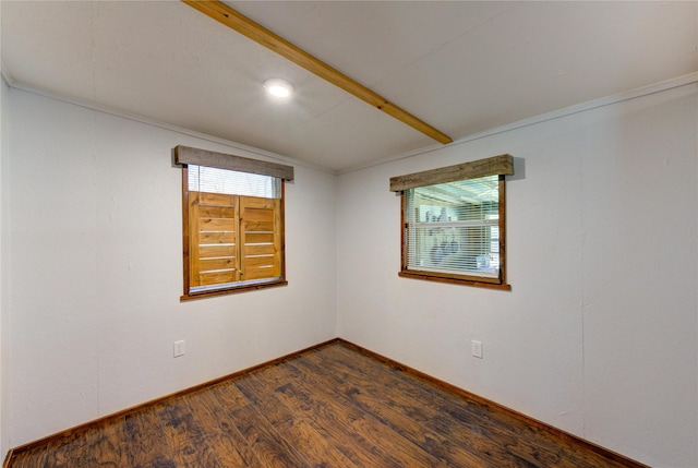 unfurnished room with dark wood finished floors, plenty of natural light, and baseboards