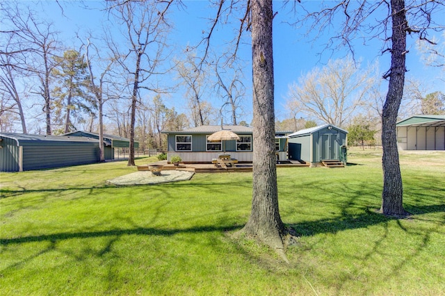 rear view of property with an outdoor structure, a lawn, a shed, and a wooden deck