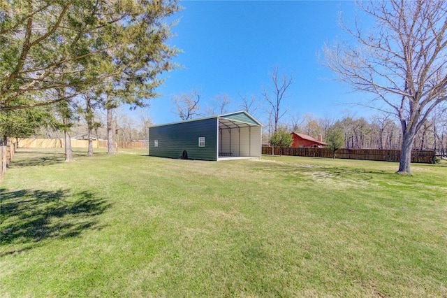 view of yard featuring a carport and fence