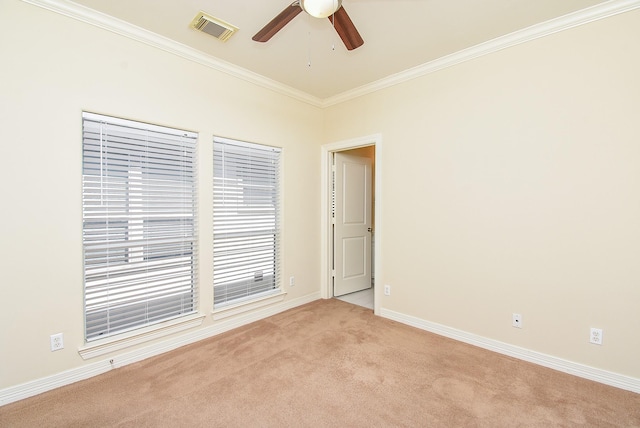 empty room featuring visible vents, crown molding, baseboards, light carpet, and a ceiling fan