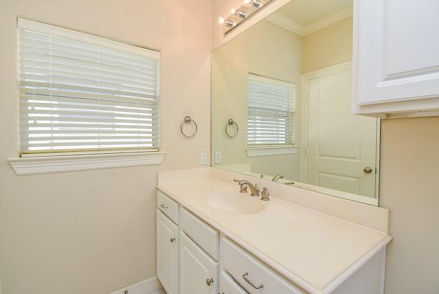 bathroom featuring ornamental molding and vanity