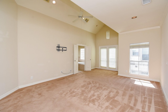 spare room with a ceiling fan, light colored carpet, baseboards, and high vaulted ceiling