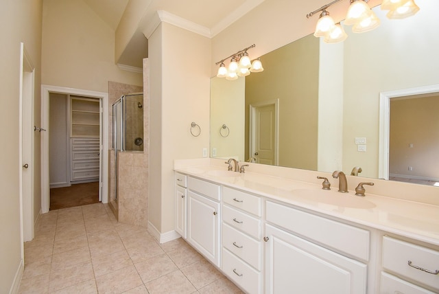 full bathroom with tile patterned flooring, a shower stall, double vanity, and a sink