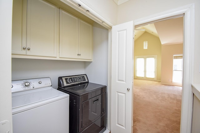 clothes washing area with separate washer and dryer, cabinet space, visible vents, and light carpet