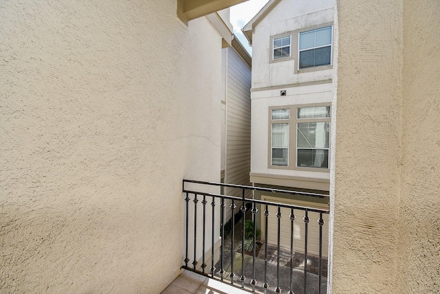 property entrance with stucco siding and a balcony