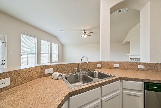 kitchen with a sink, lofted ceiling, arched walkways, a ceiling fan, and stainless steel dishwasher