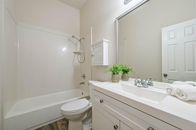 full bathroom featuring shower / washtub combination, toilet, vanity, and wood finished floors