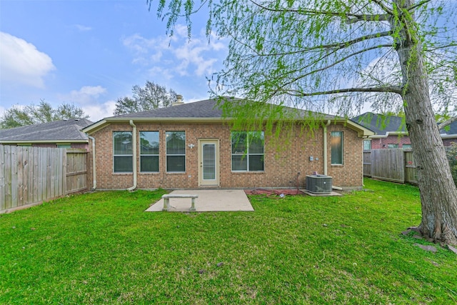 back of property featuring a patio, a lawn, a fenced backyard, and brick siding