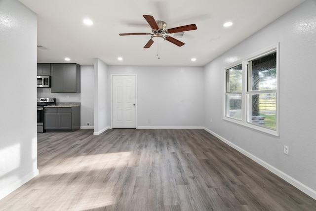 unfurnished living room with recessed lighting, ceiling fan, baseboards, and wood finished floors