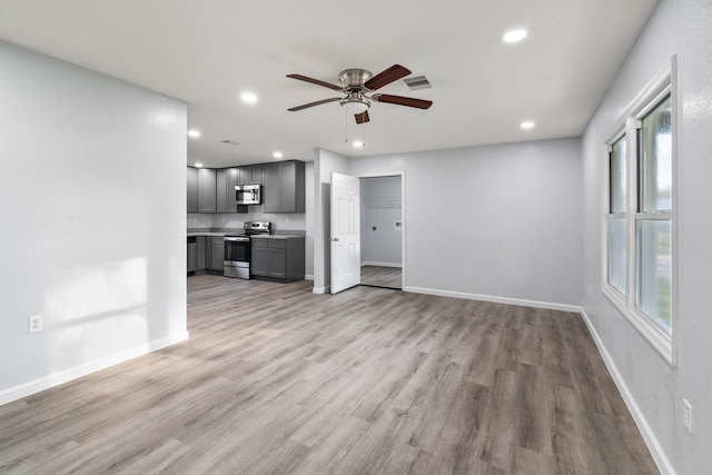 unfurnished living room featuring baseboards, visible vents, light wood finished floors, recessed lighting, and ceiling fan