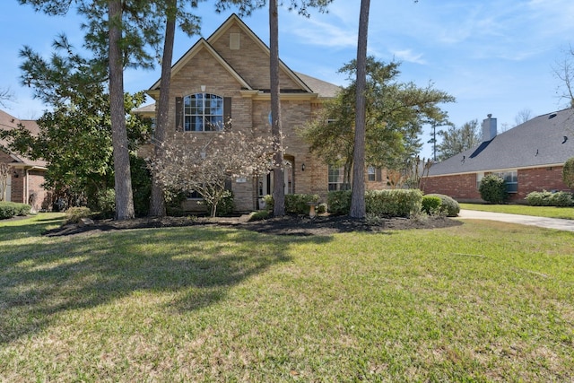 traditional-style house with a front lawn and brick siding