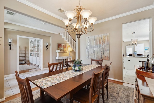 dining area with crown molding, light tile patterned floors, and visible vents