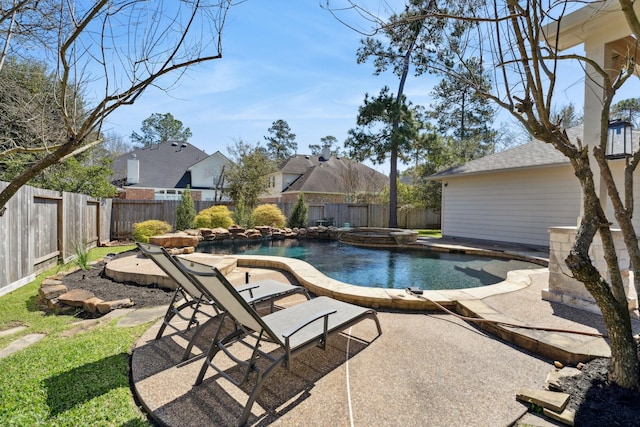 view of swimming pool with a patio, a fenced backyard, and a pool with connected hot tub