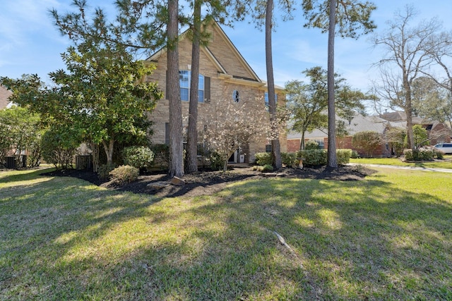 view of side of home with a yard