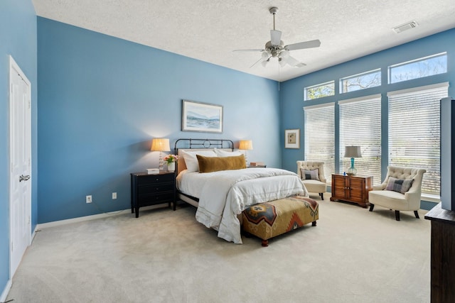 bedroom with visible vents, baseboards, a textured ceiling, and carpet flooring