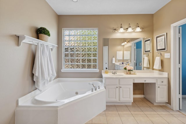 full bath with vanity, a whirlpool tub, and tile patterned flooring