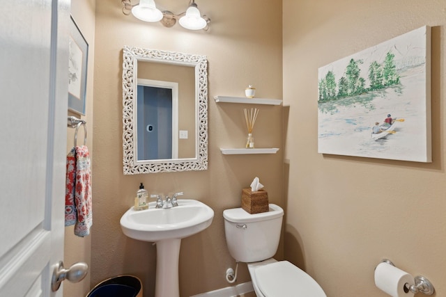 bathroom with toilet and a sink