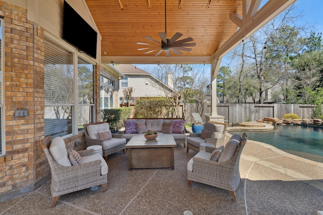 view of patio / terrace featuring a ceiling fan, a fenced backyard, a fenced in pool, and an outdoor hangout area