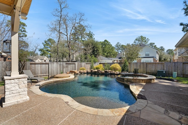 view of swimming pool with a patio, a fenced backyard, and a pool with connected hot tub