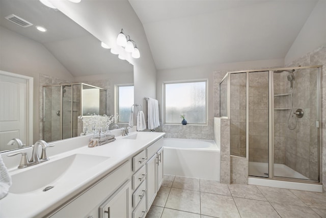 bathroom featuring vaulted ceiling, visible vents, tile patterned floors, and a sink