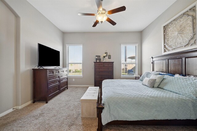 bedroom with baseboards, light carpet, and a ceiling fan