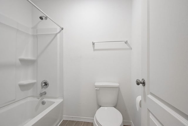 full bathroom with toilet, wood finished floors, baseboards, and shower / bathtub combination