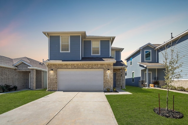 view of front of house with a yard, brick siding, concrete driveway, and an attached garage