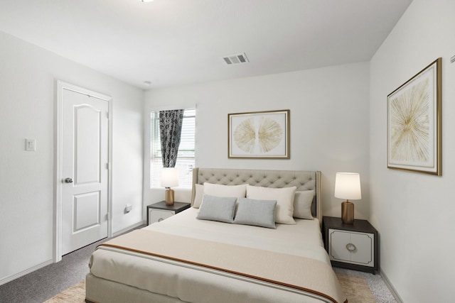 carpeted bedroom featuring baseboards and visible vents