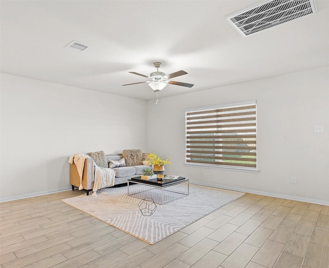 sitting room featuring visible vents, baseboards, a ceiling fan, and wood finished floors