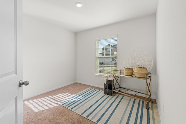 carpeted office space featuring baseboards