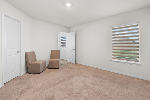 unfurnished room with baseboards and carpet flooring