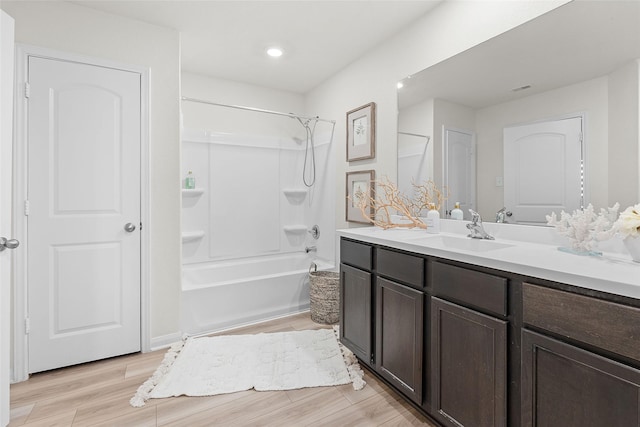 full bathroom featuring vanity, recessed lighting, wood finished floors, and tub / shower combination