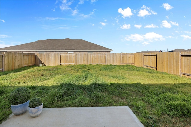 view of yard with a fenced backyard