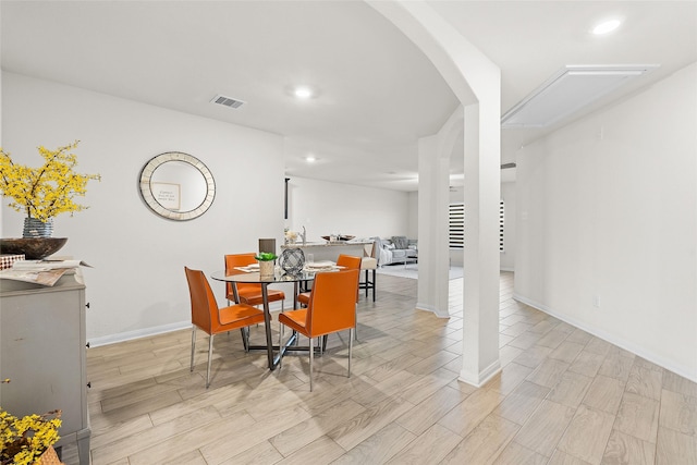 dining room featuring arched walkways, visible vents, recessed lighting, and wood finish floors