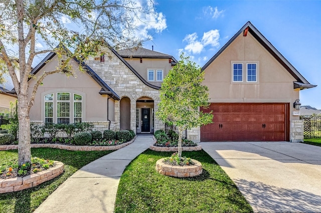 view of front of property with stone siding, driveway, and stucco siding