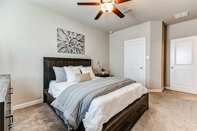 bedroom with visible vents, baseboards, and light colored carpet