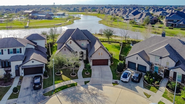 birds eye view of property featuring a residential view and a water view