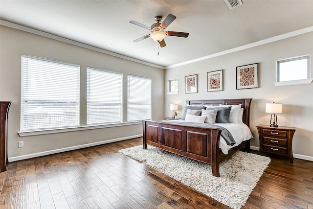 bedroom with visible vents, baseboards, ornamental molding, a ceiling fan, and dark wood-style flooring