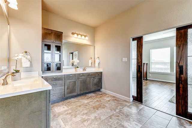 bathroom with baseboards and vanity