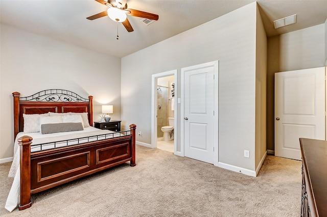 bedroom featuring light colored carpet, ensuite bathroom, and baseboards