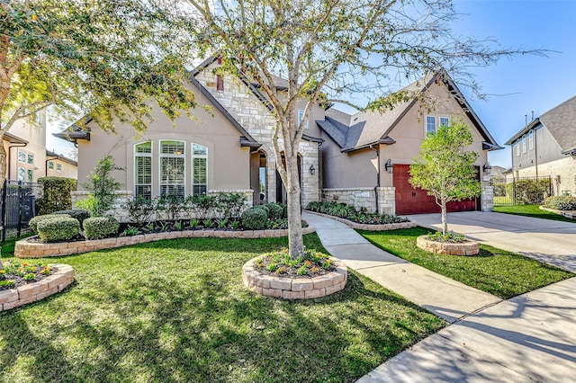 view of front of house with fence, driveway, stucco siding, a front lawn, and stone siding