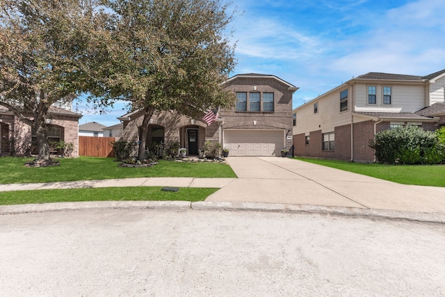 view of front of home with a front yard, fence, driveway, an attached garage, and brick siding