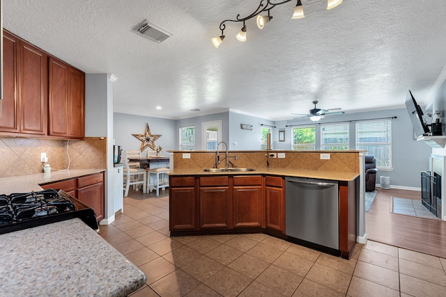 kitchen with visible vents, a sink, light tile patterned flooring, light countertops, and dishwasher