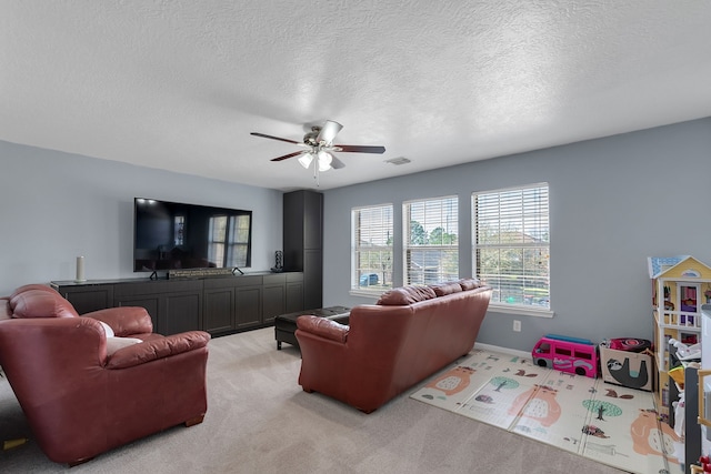 living room featuring visible vents, light colored carpet, a textured ceiling, and ceiling fan