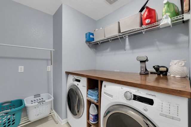 laundry area featuring baseboards, washing machine and dryer, and laundry area