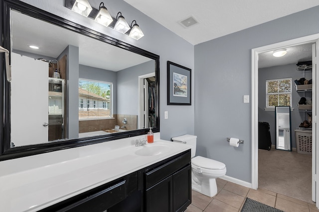 bathroom with visible vents, toilet, tile patterned flooring, baseboards, and vanity