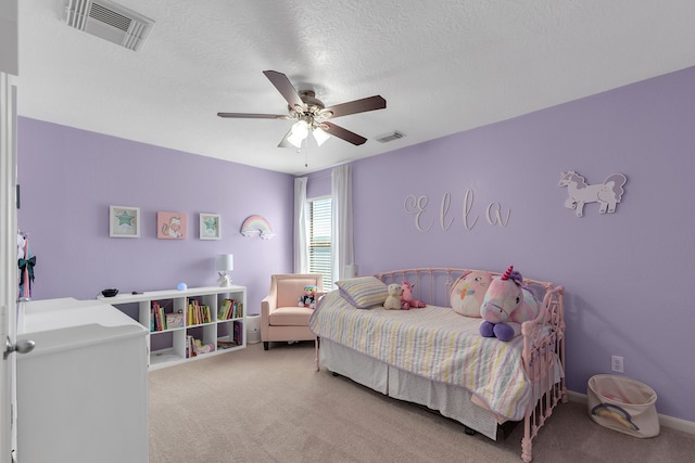 bedroom featuring light carpet, visible vents, a textured ceiling, and ceiling fan