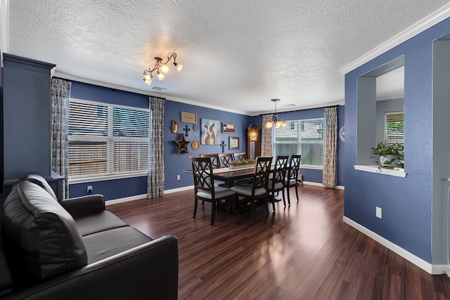 dining space with a notable chandelier, crown molding, baseboards, and wood finished floors