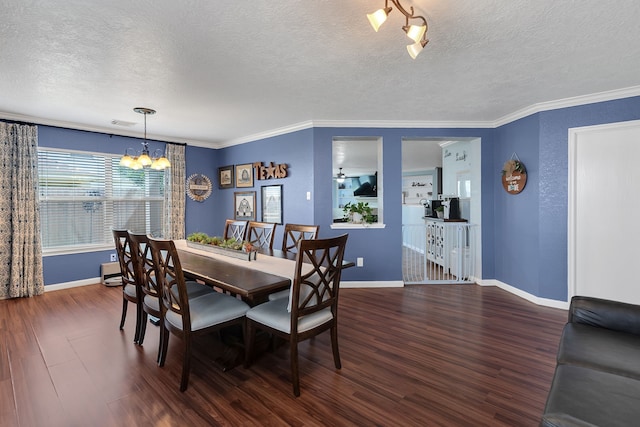 dining space with baseboards, wood finished floors, a textured ceiling, and a chandelier